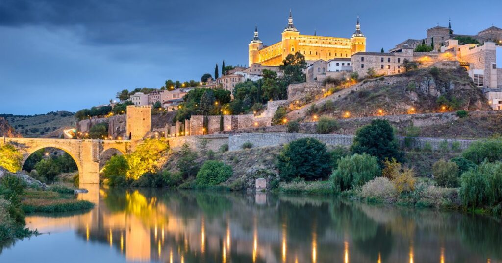 alcazar of toledo, spain - exterior view at night from river